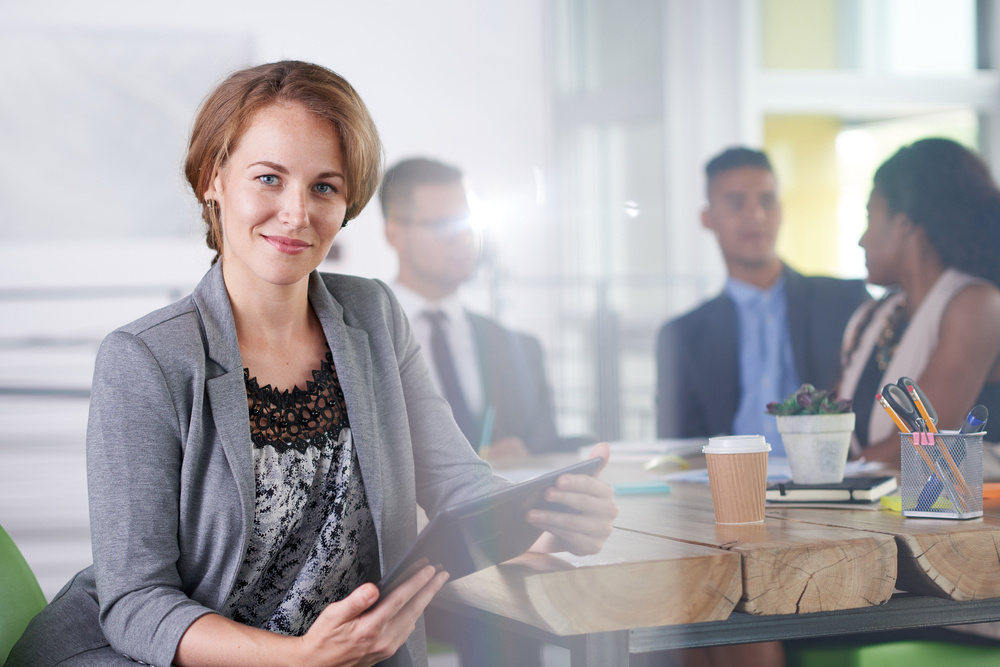 team of successful business people having a meeting in executive sunlit office